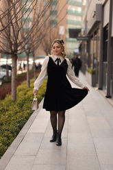 a lady in a black velvet patchwork dress